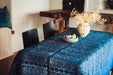 Antique handwoven Hungarian hemp table cloth with indigo wax resist dye, displayed on a wooden table.