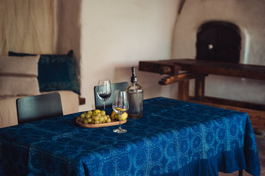 Antique handwoven Hungarian hemp table cloth with indigo wax resist dye on dining table.