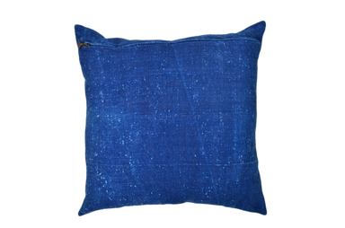 Antique handwoven decorative pillow with appliqué design and blue fabric.