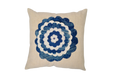 Antique handwoven decorative pillow with blue appliqué design.