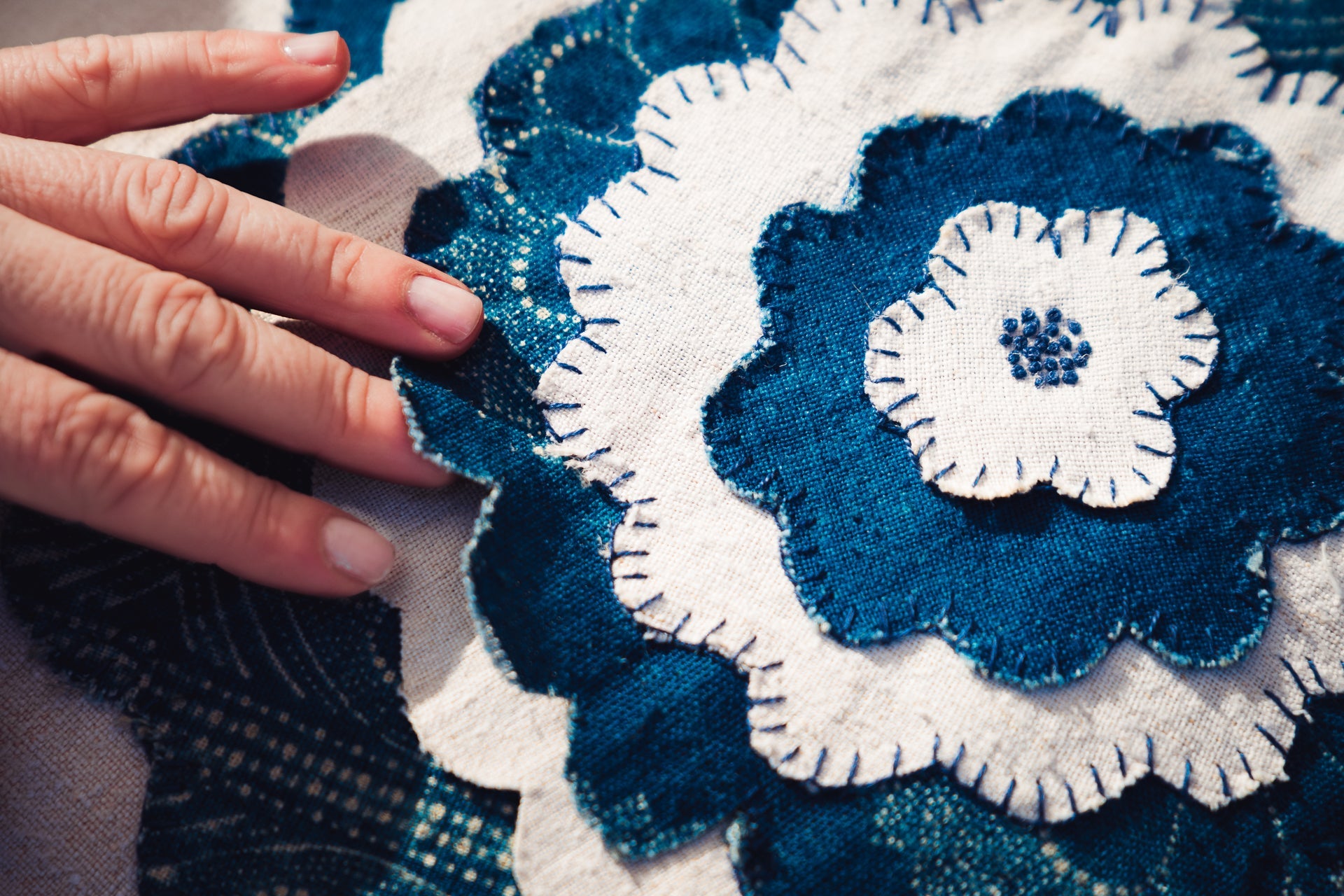 Antique handwoven decorative pillow with appliqué design.