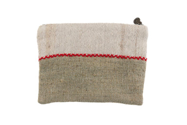 Handwoven wool bag with red stitching, hemp lining, and metal zipper.