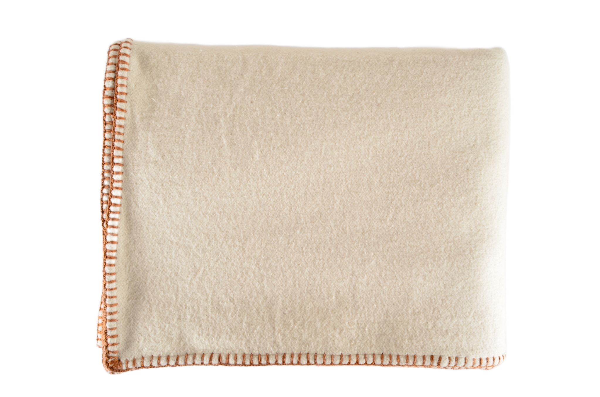 Eco-cotton throw with hand-stitched trim in cinnamon color, folded showcasing luxurious softness.