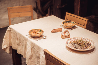 Handwoven Indian cotton table cloth on dining table with dishes.