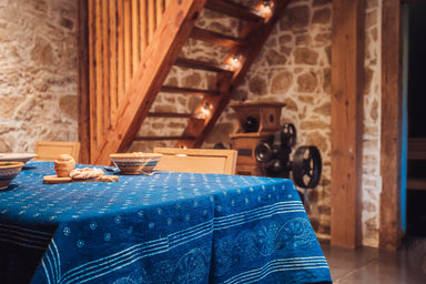 Antique handwoven Hungarian hemp table cloth with indigo wax resist pattern in rustic setting.