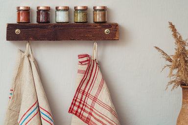 Handwoven antique Hungarian hemp towels hanging in a kitchen setting.