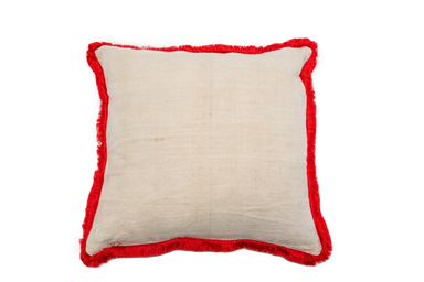 Handwoven antique Hungarian hemp pillow with red fringe detail.