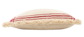 Side view of a cushion made from handwoven hemp cloth with red stripes and fringed edges.