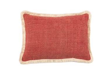 Handwoven antique Hungarian hemp pillow with red fabric and fringed edges.