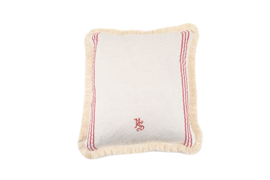 Antique handwoven Hungarian hemp pillow with red embroidery and fringed edges.